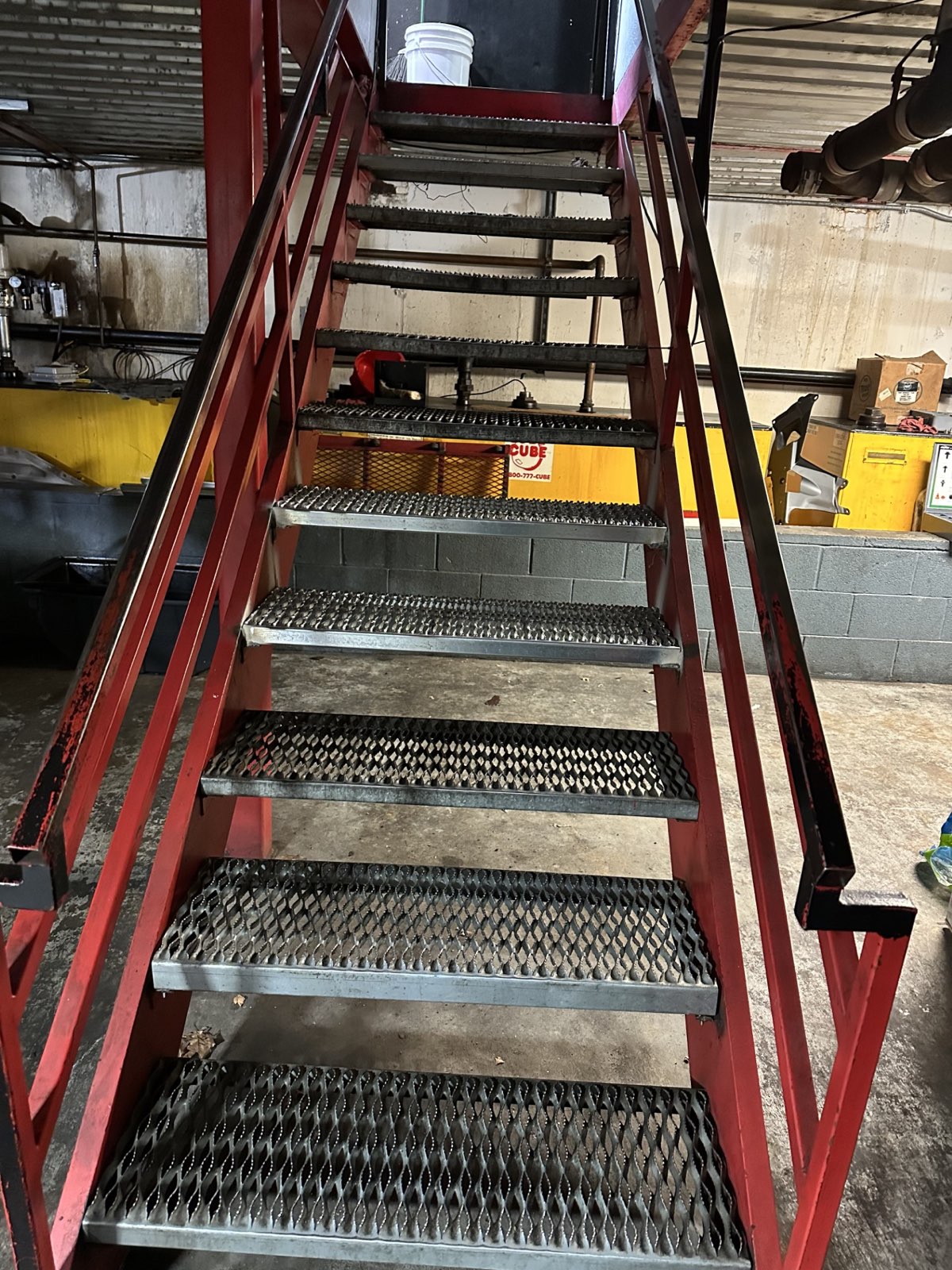 Custom steel staircase fabricated and installed for a Kwik Kar service center
