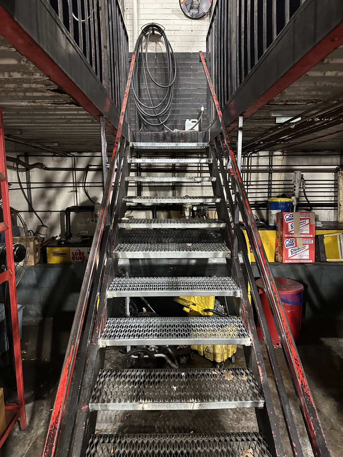 Steel staircase with expanded metal treads at a Kwik Kar service center